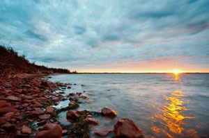 The sun setting behind the horizon, taken from the coast of Prince Edward Island, Canada